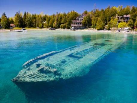 Shipwreck of the Sweepstakes, Lake Huron, Ontario, Canada: There are over 6,000 shipwrecks in the Great Lakes, most of which have not been accessed by people. But there are some wrecks visible in shallower waters, including the schooner Sweepstakes, located in Lake Huron's Big Tub Harbour in Fathom Five National Marine Park. The boat sank about 50 yards from the shore in September 1885 and has remained surprisingly intact ever since, making it a popular attraction for divers and tourists. Have you seen the schooner Sweepstakes in Ontario, Canada?