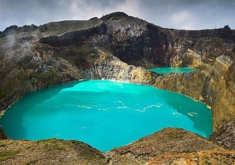 Kelimutu, Indonesia: On the Indonesian island of Flores is the tri-coloured Kelimutu volcano. The volcano has 3 lakes, each situated in one of its gaping craters, which change color as minerals and gases from volcano bubble up through the water, though locals believe it is caused by neglected ancestral souls. The Lake of Ancestors is a rich blue, the Lake of the Young Souls an intense turquoise and the Enchanted Lake is chocolate-colored. Would you like to see the Kelimutu volcano in Indonesia if you ever had the chance?