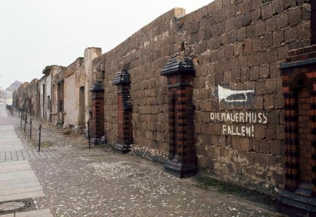 All that is left of the wall now is a small section, which has become a major tourist attraction. Today, a busy avenue runs where the wall once stood, and buildings populate the once-barren 