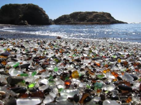 Unique Glass Beach in California near Fort Bragg in California formed after the trash dumped there for years by local residents was pounded into sand by the surf. The dumping was eventually prohibited, but the glass sand remains. Even though it has a dubious beginning, do you find this is an unusually beautiful beach?