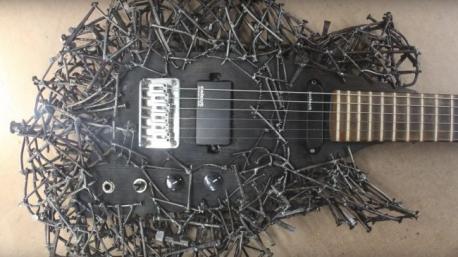 This incredible guitar, fashioned out of nails Connecticut artist Tim Sway pulled from the reclaimed pallets and boards used in other builds may just be the most 