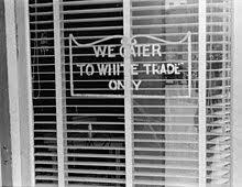 While the blatant racist signs of the 50s that proclaimed 