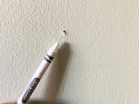 Here's a simple solutions to tiny holes in your wall, whether it be damage from children's toys, pictures that were hung at one time, or countless other mishaps. Just grab one of your children's white crayons (or even a coloured crayon -- to match -- if the wall is not white) and use it to fill those bothersome holes. Will you try this 