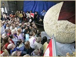 Sac City Museum Village in Iowa shows its love for popcorn in the world's largest Popcorn Ball, as this large puffy treat is in its fourth incarnation over its 27 year existence. Originating in 1995, as a way to celebrate Iowa's Sac County popcorn industry, the first ball weighed 2,225 pounds. The 2004 version got moldy and became animal feed. In 2013, a rival popcorn ball at the Indiana State Fair surpassed the 2009 winner, a 5,000 pound-version of the Iowan star, at 6,510 pounds. In June 2016, popcorn ball number four resulted from a recipe involving 2,300 pounds of popcorn, 2,500 pounds of dry syrup mix and 4,900 pounds of sugar with just enough lecithin additive to make it stick. Have you ever gone to see this attraction?