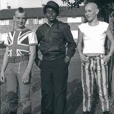 In this picture the young men display examples of trendy clothes and hairstyles. Do you believe these choices were motivated by their culture, social group, a political statement they want to project? Or are they dressed like this as a means of affordable self expression? Or do you believe they present themselves to the world looking the way they do to intimidate rather than be intimidated, send a message to anyone who might not like them and to support a grassroots musical style they may have listened to and enjoyed all of their life?