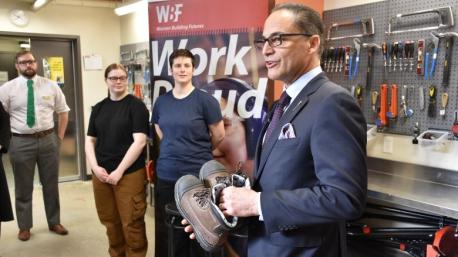 Alberta's finance minister, Joe Ceci, donated a new pair of work boots to a young woman. ​Ceci was at the Women Building Futures, a group that works to attract and train women for the construction industry. 