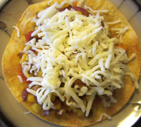 Add whatever you want, refried beans, corn, onions or mushrooms (green peppers, any other ingredients), top with more shredded cheese. Place in microwave & turn microwave on until cheese is melted. (1 min max). Do you own a microwave or toaster oven to warm your cheese?