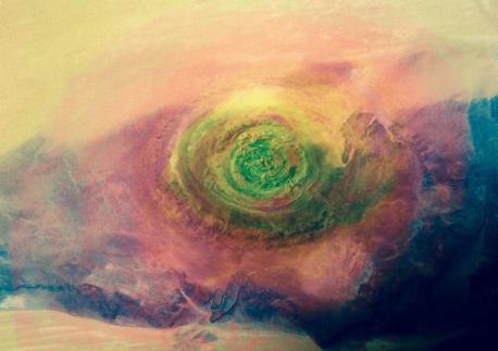 The Richat Structure - This rock formation, also known as the eye of the Sahara, is an elliptical dome in Mauritania (Northwest Africa). The deep erosion of the sedimentary rock has formed concentric rings that give the appearance of an iris and pupil emerging from the desert sands. Do you think this looks similar to an eye?