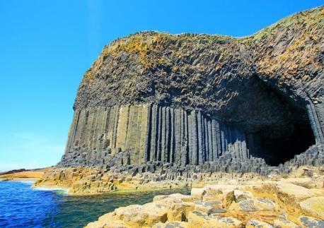 Fingal's Cave is a Scottish sea cave formed by jointed basalt columns within a lava flow. The inside and outside have geometric columns that look like carefully crafted architecture. The ancient Celts called it 