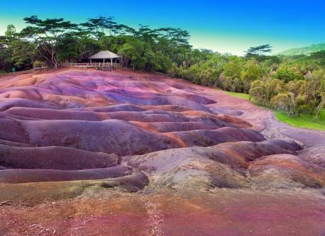 Chamarel, Mauritius - Perhaps one of the world's most unique geographical phenomena, the Seven Colored Earth in Chamarel is sure to mesmerize you. Located in the middle of a lush green landscape, the Seven Colored Earth is an area of sand dunes in hues of yellow, violet, green, red, brown, blue, and purple. After viewing the colorful sand dunes, you can explore the local coffee shop, browse the souvenir store, and even catch a glimpse of the beautiful Chamarel Waterfall. Ready to travel yet?