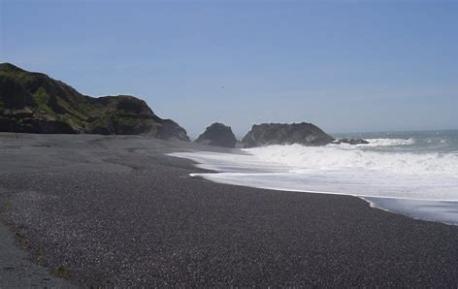 Black Sands Beach - Shelter Cove, California is at the south end of a walkable coastline that is over 20 miles long between Shelter Cove to Mattole River Campground. The Lost Coast Trail takes backpackers north to numerous wilderness camp spots and remote places. To the north is a vast beachcombing shoreline and to the south is Little Black Sands Beach. This entire area is protected by the Bureau of Land Management in the King Range National Conservation Area. Have you visited this beach or any other <black> sand beach?