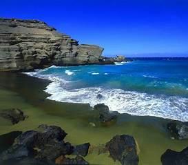 Papakolea Beach - Hawaii's Big Island - Emerald beach is caused by a silicate called olivine, a heavy mineral that tends to stick around instead of washing out to sea. There are 4 <green> beaches in the world, but this is the only one in the United States. It sits on a tuff ring — the site of a volcano eruption that happened thousands of years ago. The olivine is from ancient lava flows, and the color ranges from a pea soup green-gold to deep jade. There is also 