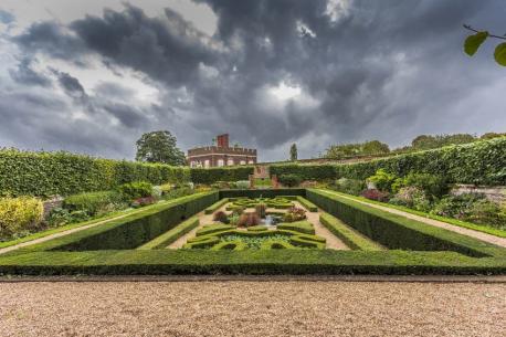 Hampton Court Palace Maze — Surrey, U.K. - This maze dates back to the 17th century, and is the oldest hedge maze in the U.K. It is shaped like a trapezoid, and is notoriously difficult to navigate. George London and Henry Wise created it using a puzzle maze strategy, meaning there is more than one path. At the time, this concept was fairly groundbreaking, considering most other mazes followed one path from an outer circle, also called a unicursal maze. Have you visited this site?