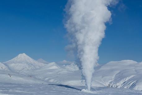 Ice volcanoes look like small snowy hills that form over a frozen body of water. They can reach from 3 to 25 feet tall. Ice volcanoes form in large arcs along bodies of water with multiple volcanoes making up each arc. Although this eruption isn't considered dangerous, we are viewing it from a safe distance. Perfect timing! We have arrived as the wave is rolling in just right, and water is forced up through the tops of the hills, and shoots out of the holes in the frozen sheet of ice. That was a spectacular 