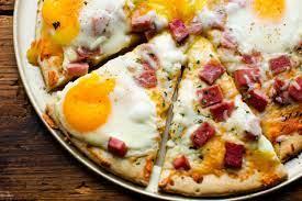 Add Fried Eggs for Breakfast Pizza. Reheat the pizza, then add a fried egg on top. Cook the egg sunny side up or over easy then, let the yolk run all over the pizza for even more delicious flavor.