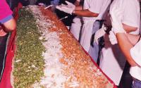 (1999) The world's largest Taco measured 15 feet long by 29 inches wide and weighed 747 lbs, constructed at the 2nd Annual Houston Taco Festival on 5 May 1999, in Houston Texas, USA. LA TAPATIA. 20 Employees were involved in the preparation of this huge Taco they worked proximally 16 hours from pilling of the skin cutting of fat from beef skirt ( Fajita) Marinating ,then Grilling ,slicing ,chopping of so we could serve individually 2 Tacos per Person. out the 745 Lb Fajitas we made about 5000 regular size TACOS ,more than 2000 People showup to see and taste some of that Big Taco , all of this was served at the Dream poll in front of Houston City Hall Downtown. Have you ever participated or been at a 