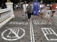 Distracted driving laws have sprung up around the world to cut down on drivers who text behind the wheel. That was not enough for one Chinese property manager with a sense of humor. Last week, pedestrians in the city of Chongqing discovered a designated cellphone lane to walk in while they played Candy Crush or talked on WeChat. 