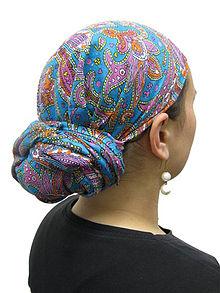 The tichel (Yiddish טיכל tikhl), also called a mitpachat (Hebrew מִטפַּחַת miṭpaḥat), is a headscarf worn by many married Orthodox Jewish women in compliance with the code of modesty known as tzniut. Tichels can range from a very simple plain color cotton square with a simple tie in the back to very elaborate fabrics with very complex ties using multiple fabrics. As with any other form of clothing, the tichel is influenced by fashion. Have you heard or possibly seen a woman wearing a tichel (see photo)?