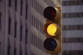 Finally, you're approaching a yellow caution light, what do you do?