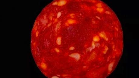 The image that went viral on social media resembled a fiery red ball with light spots that were shining in a terrifying manner on a pitch-black background. In this photo are we looking at A: A celestial body or B: A spicy slice.?