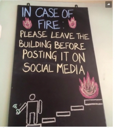 This sign was probably inspired by some of those clips on YouTube. If I am in a car crash and going up in flames please rescue me first before you film me. Have you ever filmed an accident and posted it on social media?