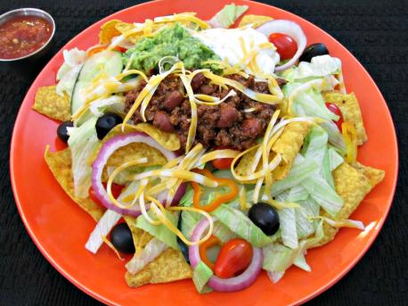 There are some variations of Taco salad mostly involved replacing the tortilla shell or bowl with nacho chips, tostadas, ... and of course the toppings can be selective according to what you like. Which of the Taco salad variations below would you like to try? (The photo is Taco salad with Nacho chips and no tortilla shell)