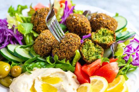 Falafel is often served in a pita, samoon, or wrapped in a flatbread known as taboon. The falafel balls may be topped with salads, pickled vegetables, and hot sauce, and drizzled with tahini-based sauces. Are you interested in eating Falafel either with salad or wrap, pita, bread,... of your choice?