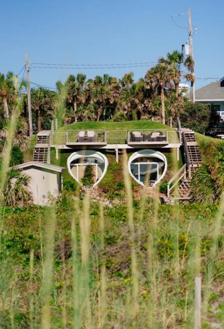 Florida: The Dune House - The Dune House in Jacksonville was built in the '70s by architect William Morgan, who saw an opportunity to create an environmentally-friendly home in a sand dune created after Hurricane Dora in 1964. Taking the blank canvas that nature left behind, Morgan insulated the home using the surrounding earth—which inevitably camouflages the home to onlookers. The Dune House was also built using no right angles—just curves. Would you feel safe living in a sand dune?