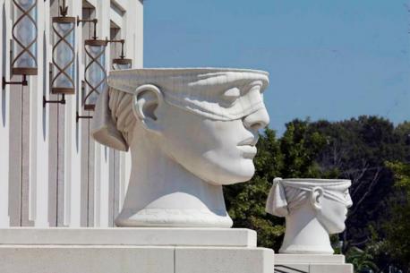 Louisiana - If you visit downtown Lafayette you will see the city has pulverized much of its original downtown -- leaving a lifeless shell of its former self. You will also find an attractive modern courthouse with two large and nicely detailed sculptures on either end of the structure, showing the head of 