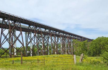 Iowa: Kate Shelley High Bridge - Legend has it Kate Shelley saved a trainload of people from plummeting to their deaths after a storm destroyed a section of railroad near Honey Creek. She risked her life by crawling along the remaining train trestle to the closest depot, sounding the alarm and halting a passenger train she knew to be approaching. The heroine arrived in time and succeeded in stopping it in its tracks. This bridge was completed some 20 years later in 1901, and was named after Shelley to commemorate her actions. Have you ever visited this bridge?