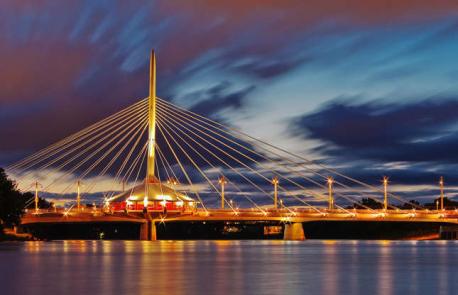 Manitoba, Winnipeg - Esplanade Riel Bridge - One of Winnipeg's architectural highlights, the Esplanade Riel is a footbridge located just north of the junction of the Red and Assiniboine rivers, connecting the city's French Quarter with the popular Forks area. Named after politician Louis Riel, the dramatic bridge consists of an impressive 187-foot (57m) tower with cables splaying from the top. A round pavilion fitted with a commercial space sits at the base of the tower. Have you ever visited this bridge?