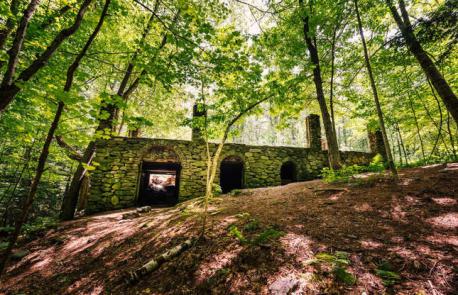 New Hampshire: Madame Sherri's Castle, Chesterfield - Swallowed up by the Madame Sherri forest, these enchanting ruins have a tale to tell. The castle was once owned by eccentric Madame Sherri, a costume designer with a penchant for lavish parties. It began to crumble away after Madame Sherri left the property behind, and was all but destroyed by a fire in 1962. Still standing are some of the castle's stone walls, carved out with arches, and a swirling stairway. Hikers can see the ruins on an easy trail through the forest. Have you ever visited this attraction?