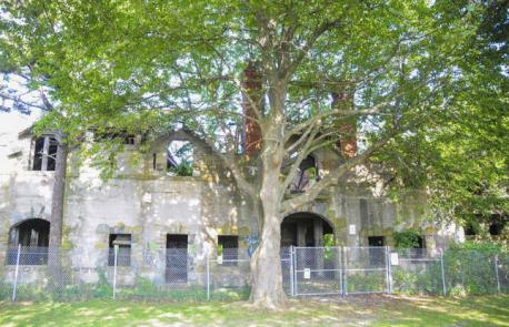 Rhode Island: The Bells, Newport - Newport's leafy Brenton Point State Park is home to an ambient abandoned building that's been left to ruin for decades. The Bells was once a lavish estate, built in 1876 for lawyer Theodore M Davis, who crammed the property with relics from his significant excavation work in Egypt. The mansion itself was ravaged by fire in the 1960's, and today all that remains are the once-grand stables and carriage house. The ruin is guarded by a metal fence, so visitors can't get right up close – but they can get near enough for a good view. Have you ever visited this attraction?