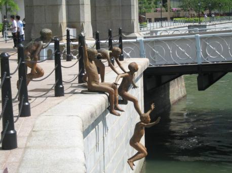 On the south bank of the Singapore River near the historic Cavenagh Bridge is a gravity-defying sculpture of five boys diving off the quay called 