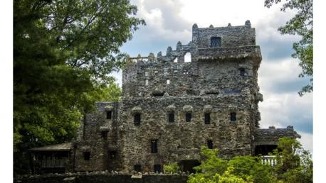 Perched high above the Connecticut River, Gillette Castle looks like a long-abandoned medieval fortress. This castle was originally known as Seventh Sister. The castle was designed, built, and inhabited by the eccentric and renowned American stage actor William Gillette. Today, Gillette Castle is owned and maintained by the State of Connecticut. Visitors can tour the castle's whimsical winding rooms or explore the beautiful surrounding trails. Would you want to visit this castle?