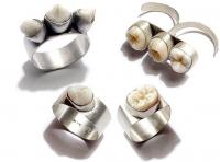 Australian silversmith Polly van der Glas has created a strange collection of silver jewelry embedded with teeth! She also uses human hair in her designs. Like the young art student from England, she is fascinated by the idea of how we often view good hair and teeth as beautiful until they are shed and then we no longer see them as having value and often have an aversion to them. Would you wear a piece of jewelry made from human teeth?